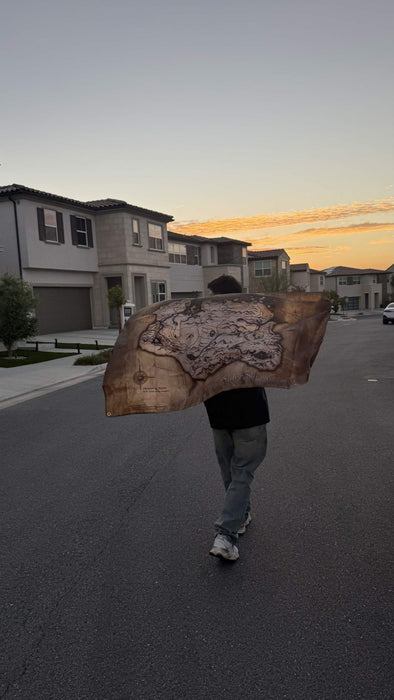 A 3x5 map flag held open in the street at sunset