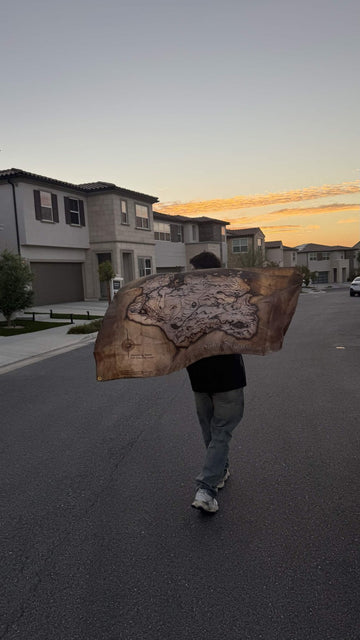 A 3x5 map flag held open in the street at sunset