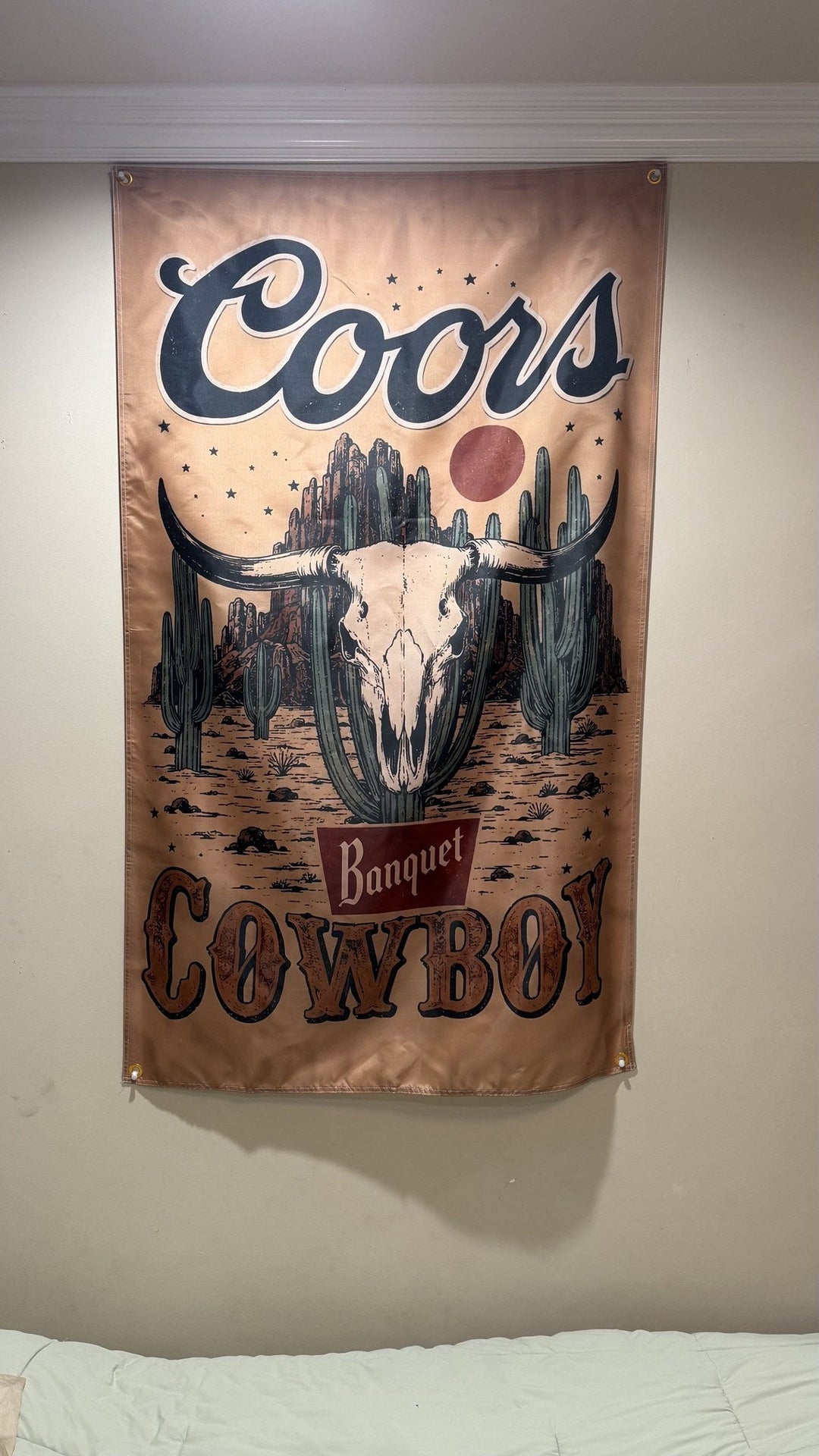 Coors Banquet Cowboy flag hanging on a wall with corner grommets