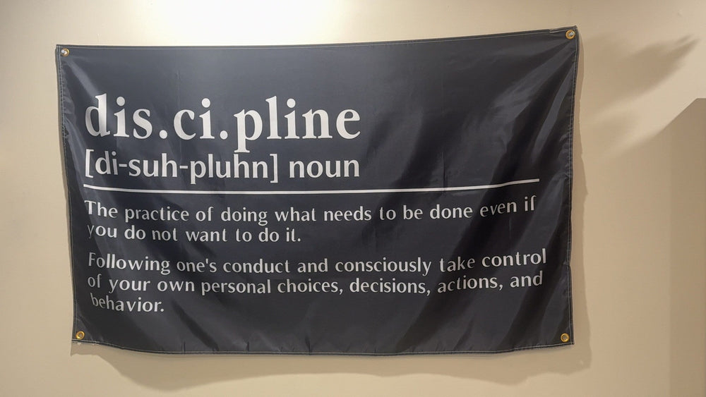 Discipline definition flag hanging on a wall with corner grommets