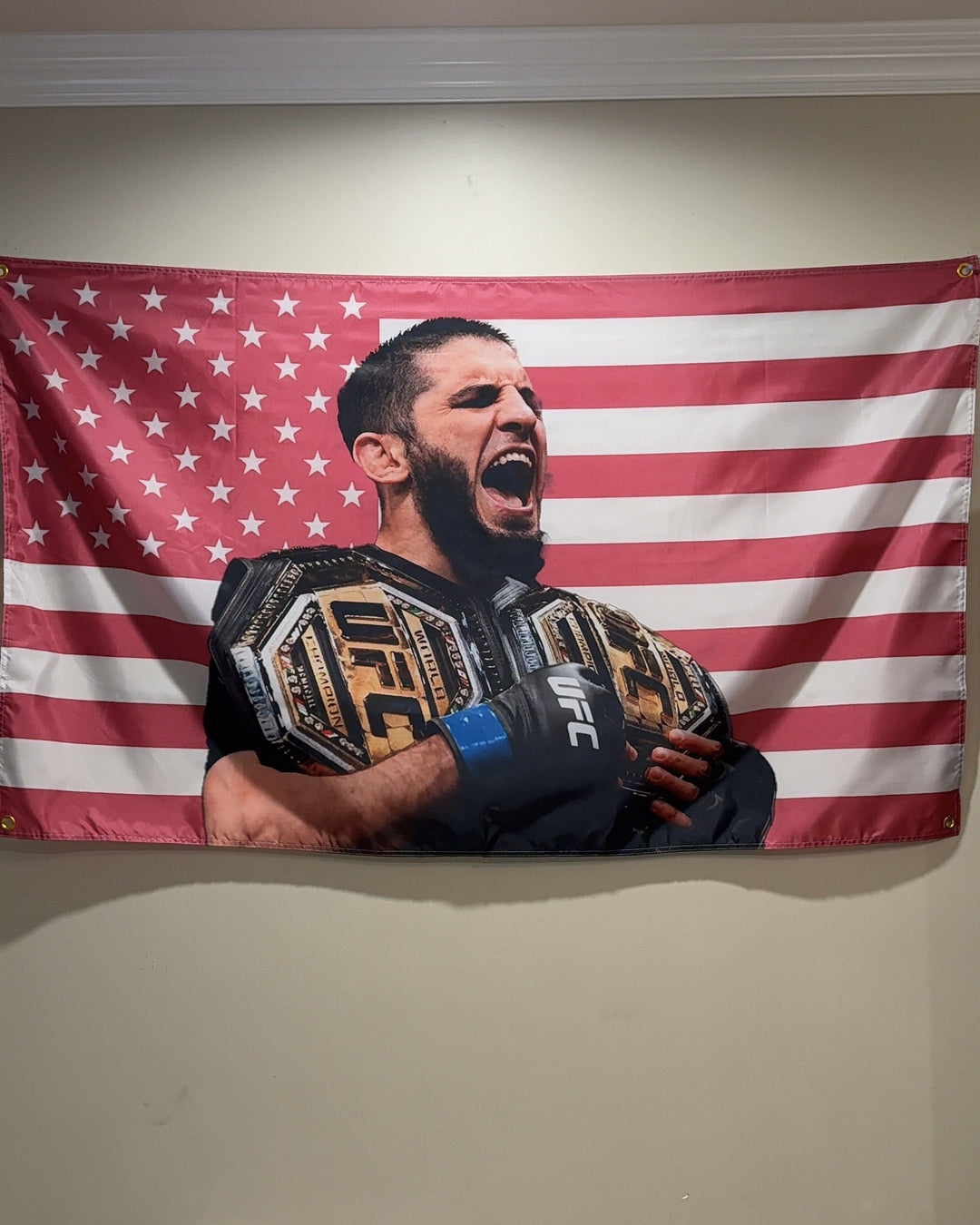 Islam Makhachev pink American flag hanging over a bed