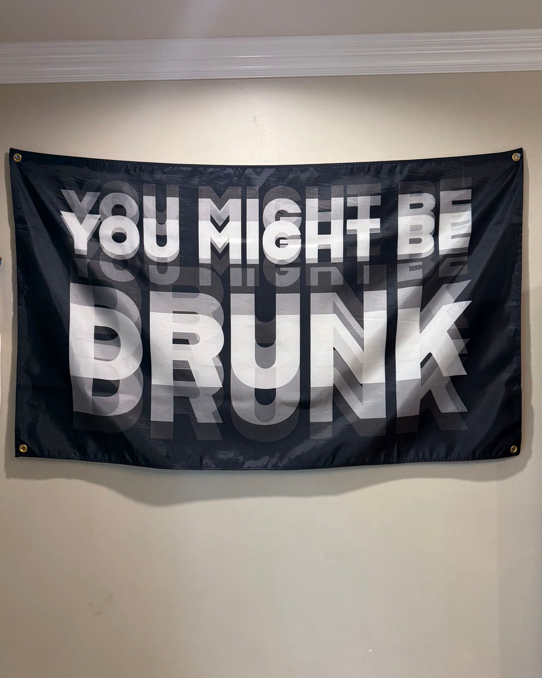 You Might Be Drunk flag hanging over a bed